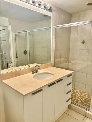 a bathroom with a shower and a sink