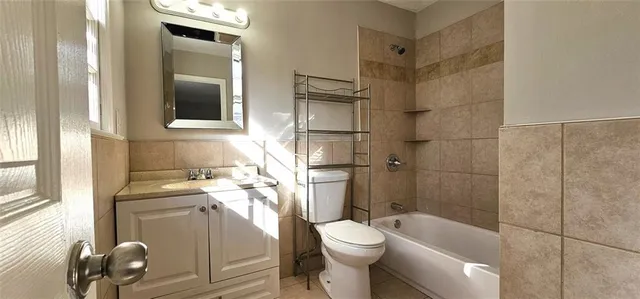 a bathroom with a toilet sink and shower