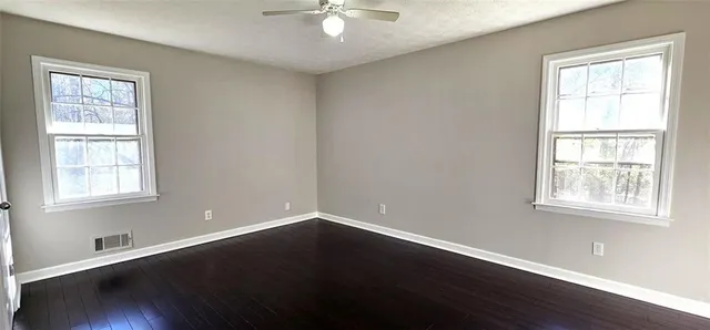 a view of wooden floor and windows in a room