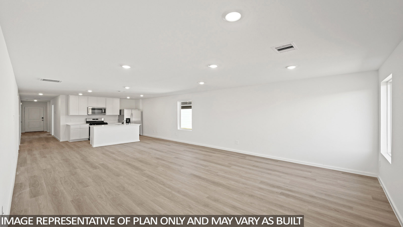165 Baby Calf Roping Road Jarrell, TX 76537 - Photo 6 of 24 An open-concept living space with a contemporary kitchen flows seamlessly across beautiful hardwood flooring.