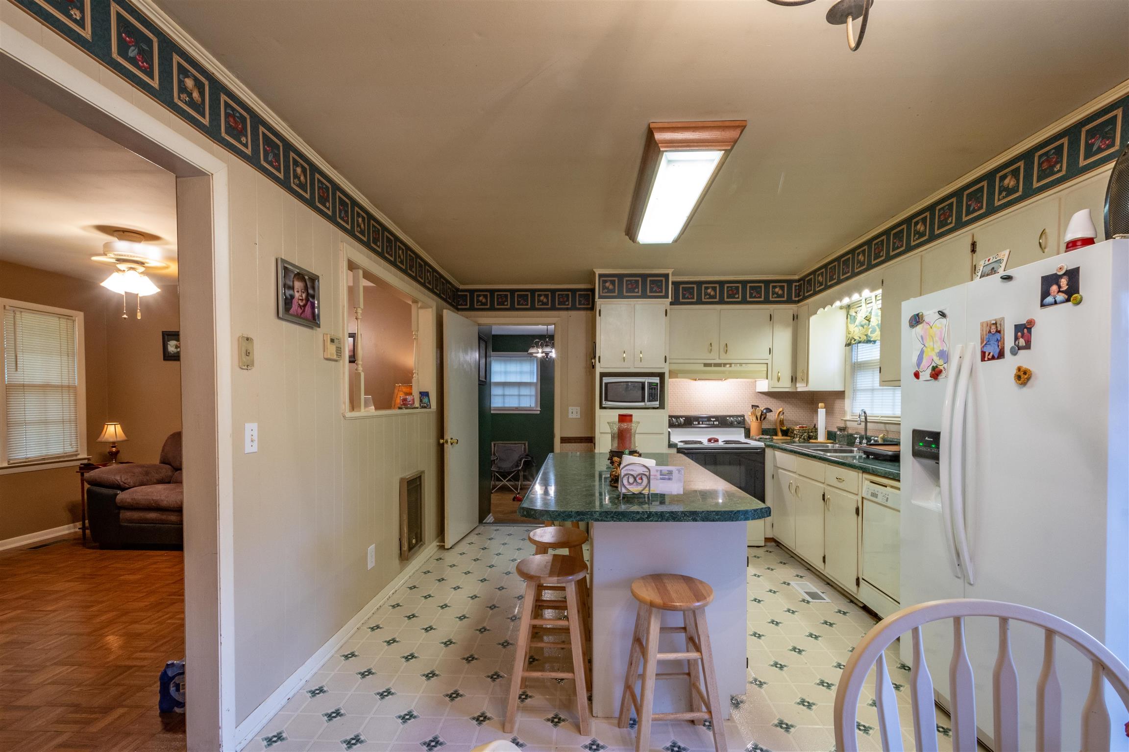 1309 Oak Grove Road Goodspring, TN 38460 - Photo 15 of 29 a kitchen with stainless steel appliances granite countertop a refrigerator a stove top oven a sink and dishwasher