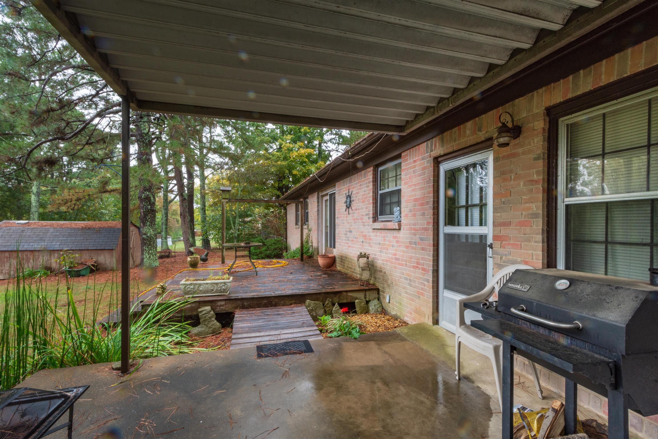 1309 Oak Grove Road Goodspring, TN 38460 - Photo 27 of 29 a backyard of a house with barbeque oven table and chairs