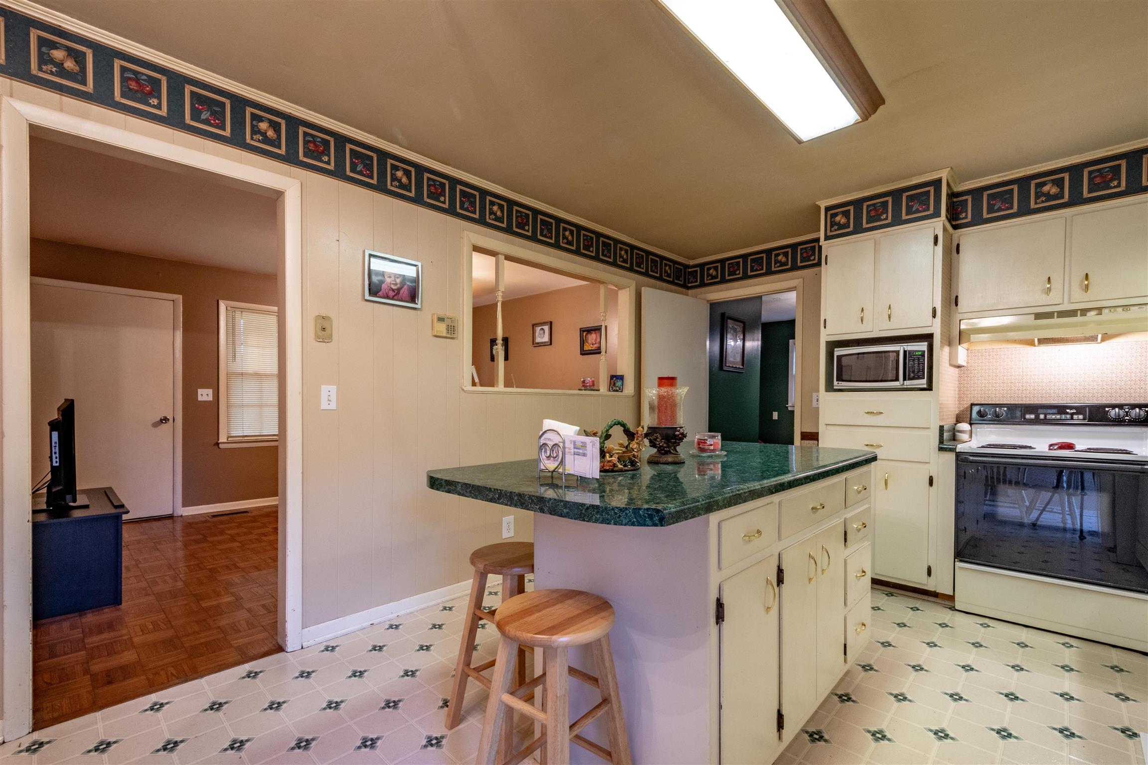1309 Oak Grove Road Goodspring, TN 38460 - Photo 7 of 29 a kitchen with stainless steel appliances kitchen island granite countertop a sink and cabinets