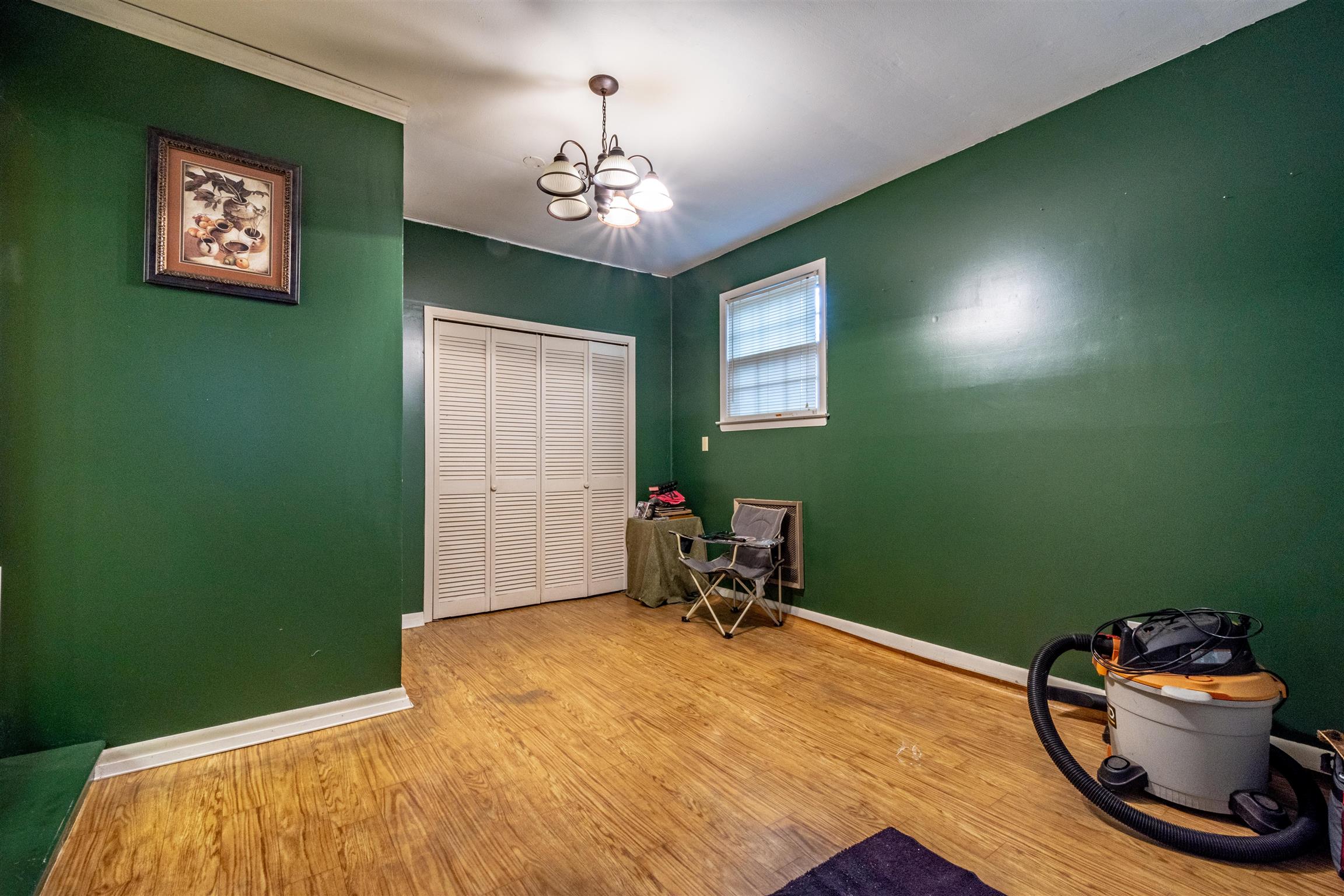 1309 Oak Grove Road Goodspring, TN 38460 - Photo 9 of 29 a bedroom with a bed and a chandelier