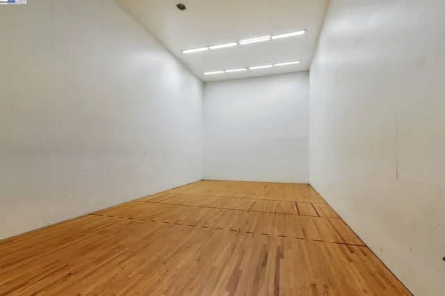 a room with pool tables and a rug