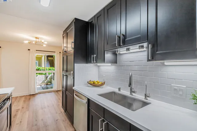 a kitchen with a sink and a refrigerator