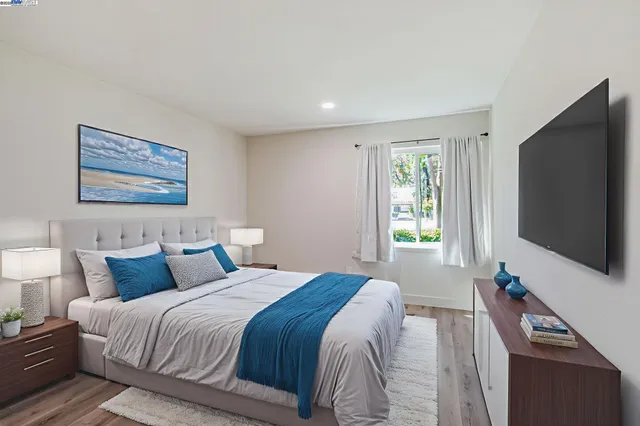 a bedroom with a bed and a flat screen tv