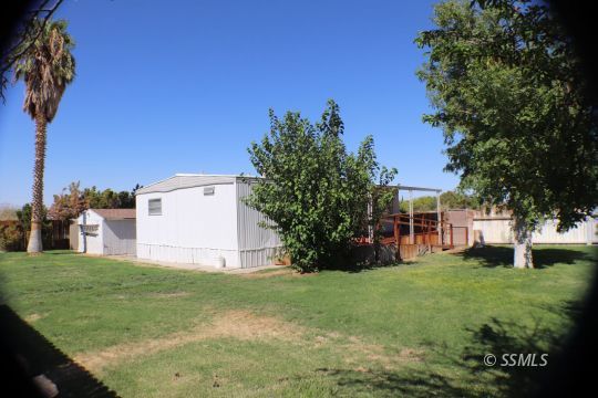 1241 South Mahan Street Ridgecrest, CA 93555 - Photo 19 of 28 a view of a house with a yard