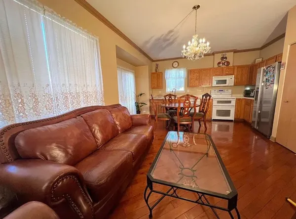 a living room with furniture and a chandelier