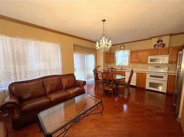 a kitchen with stainless steel appliances a sink cabinets and wooden floor