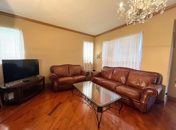 a kitchen with stainless steel appliances granite countertop a refrigerator a sink dishwasher a stove and white countertops with wooden floor