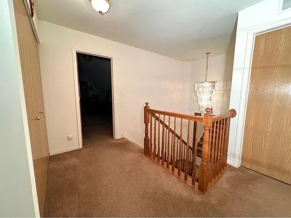 a bedroom with bed and wooden floor