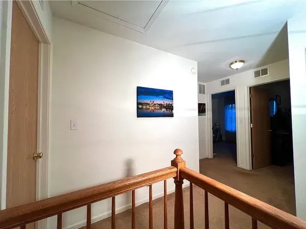 a bedroom with a bed flat screen tv and a window