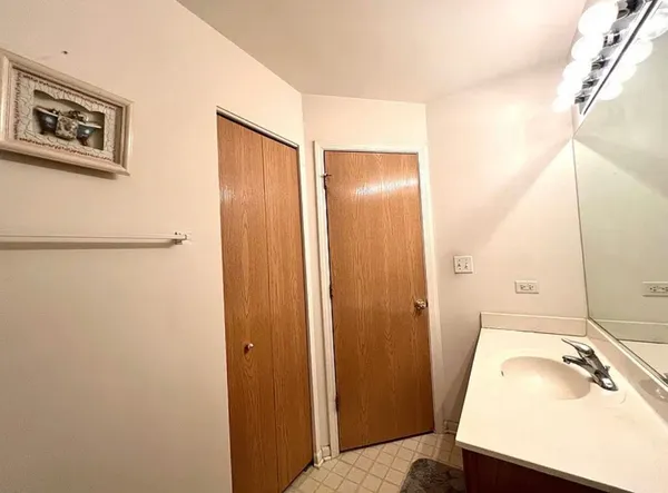 a bed sitting in a room next to a lamp