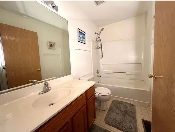 a bedroom with a bed and a mirror