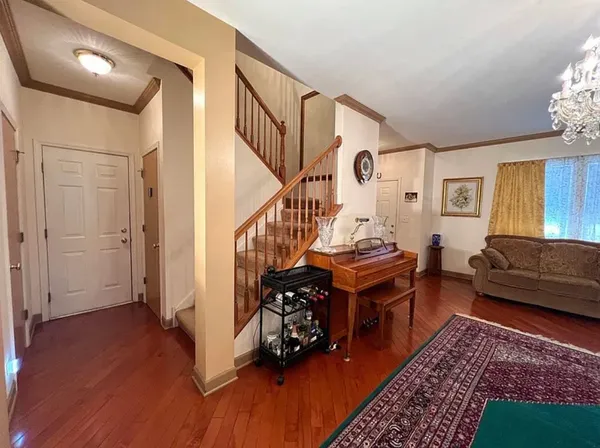 a living room with furniture a chandelier and a fireplace