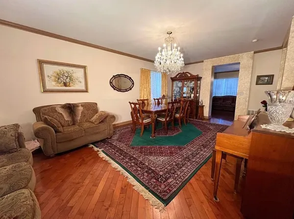 a living room with furniture and a chandelier