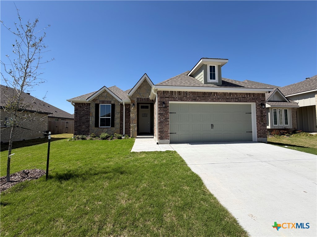 1985 Mercer Street Nolanville, TX 76559 - Photo 1 of 24 a front view of a house with a garden and yard