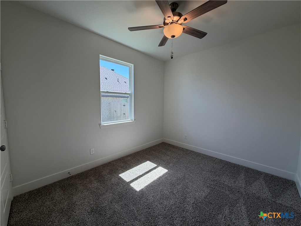 1985 Mercer Street Nolanville, TX 76559 - Photo 12 of 24 an empty room with windows and fan