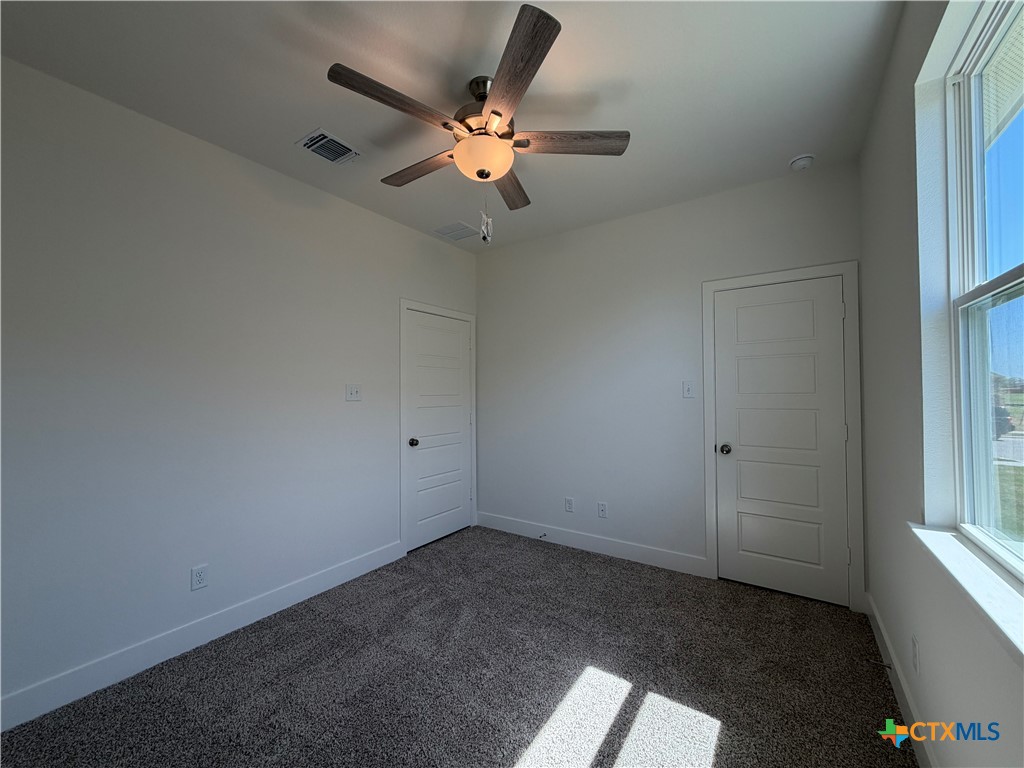 1985 Mercer Street Nolanville, TX 76559 - Photo 13 of 24 an empty room with windows and fan