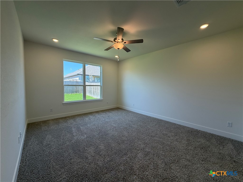 1985 Mercer Street Nolanville, TX 76559 - Photo 19 of 24 en empty room with windows and ceiling fan