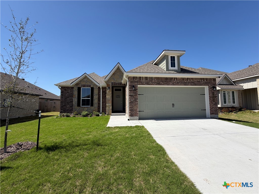 1985 Mercer Street Nolanville, TX 76559 - Photo 2 of 24 a front view of a house with a yard and garage