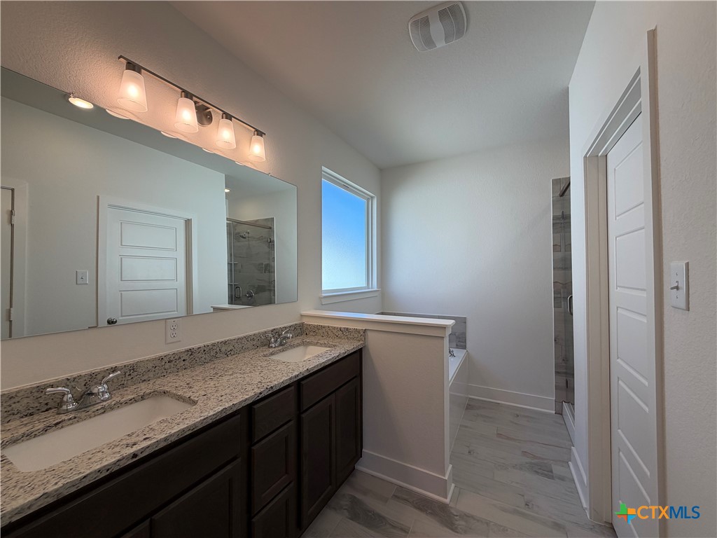 1985 Mercer Street Nolanville, TX 76559 - Photo 23 of 24 a bathroom with a granite countertop sink and a mirror