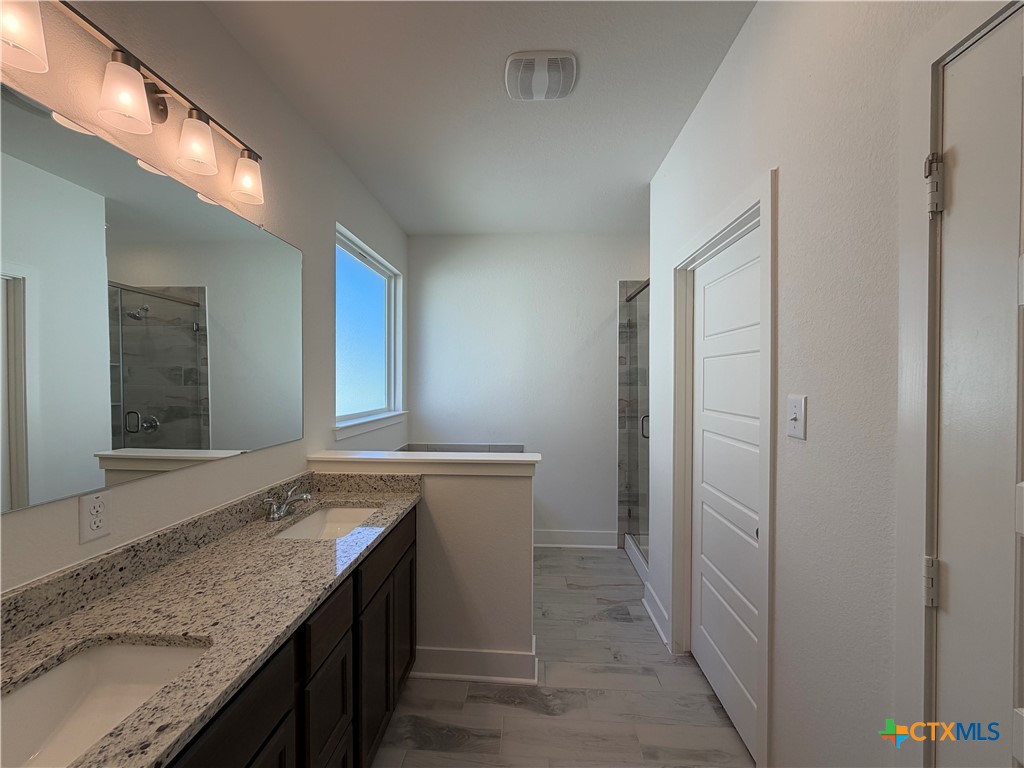 1985 Mercer Street Nolanville, TX 76559 - Photo 24 of 24 a bathroom with a granite countertop sink and a mirror