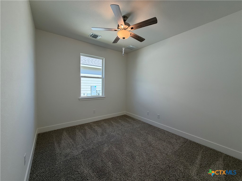 1985 Mercer Street Nolanville, TX 76559 - Photo 5 of 24 an empty room with windows and fan