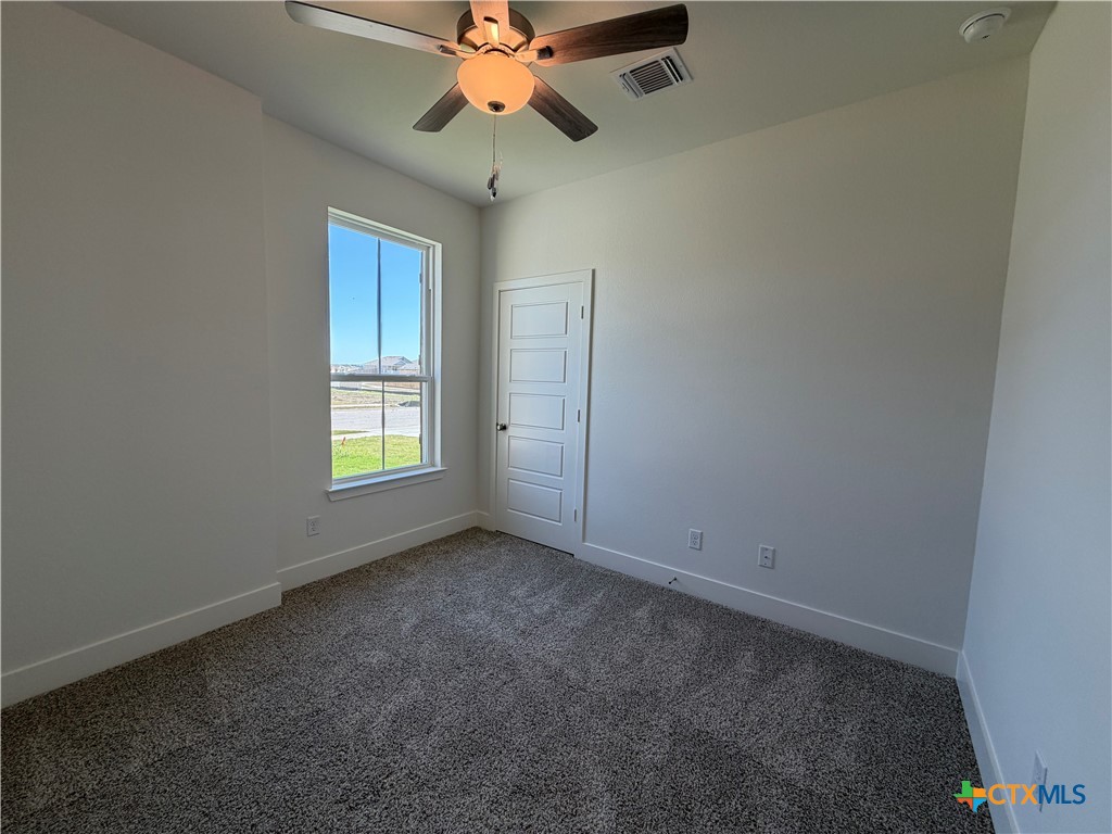 1985 Mercer Street Nolanville, TX 76559 - Photo 8 of 24 an empty room with windows and fan