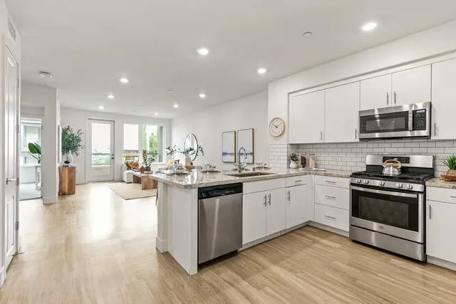 a kitchen with sink a stove and cabinets
