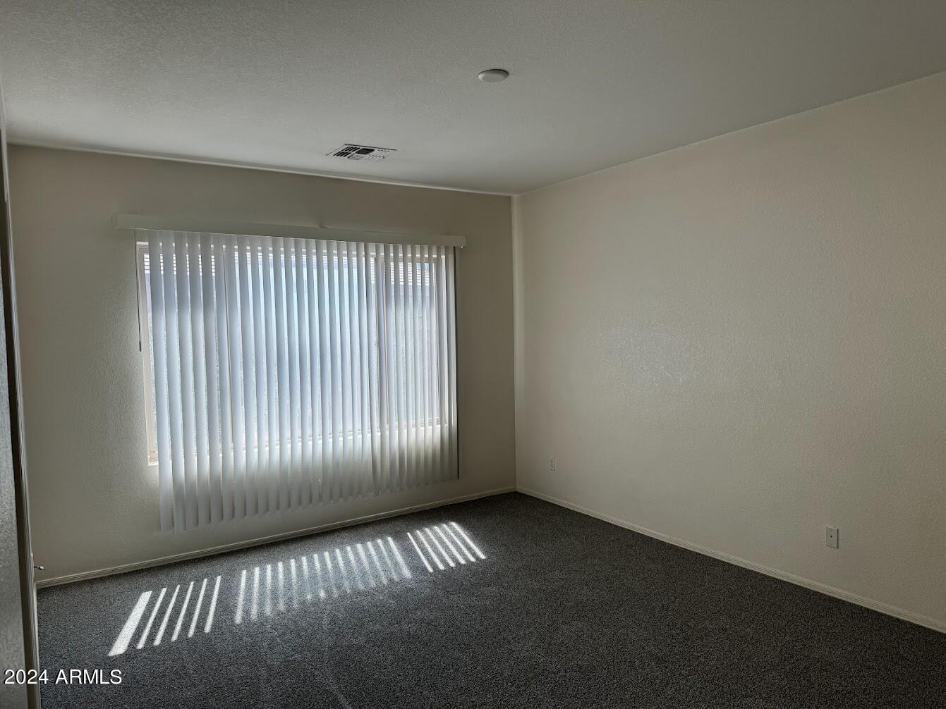 9401 West Berkeley Road Phoenix, AZ 85037 - Photo 14 of 27 wooden floor in an empty room with a window