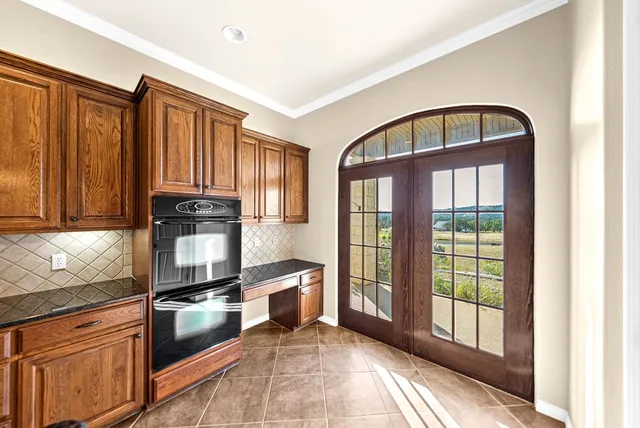 a view of a kitchen with a large window and chandelier