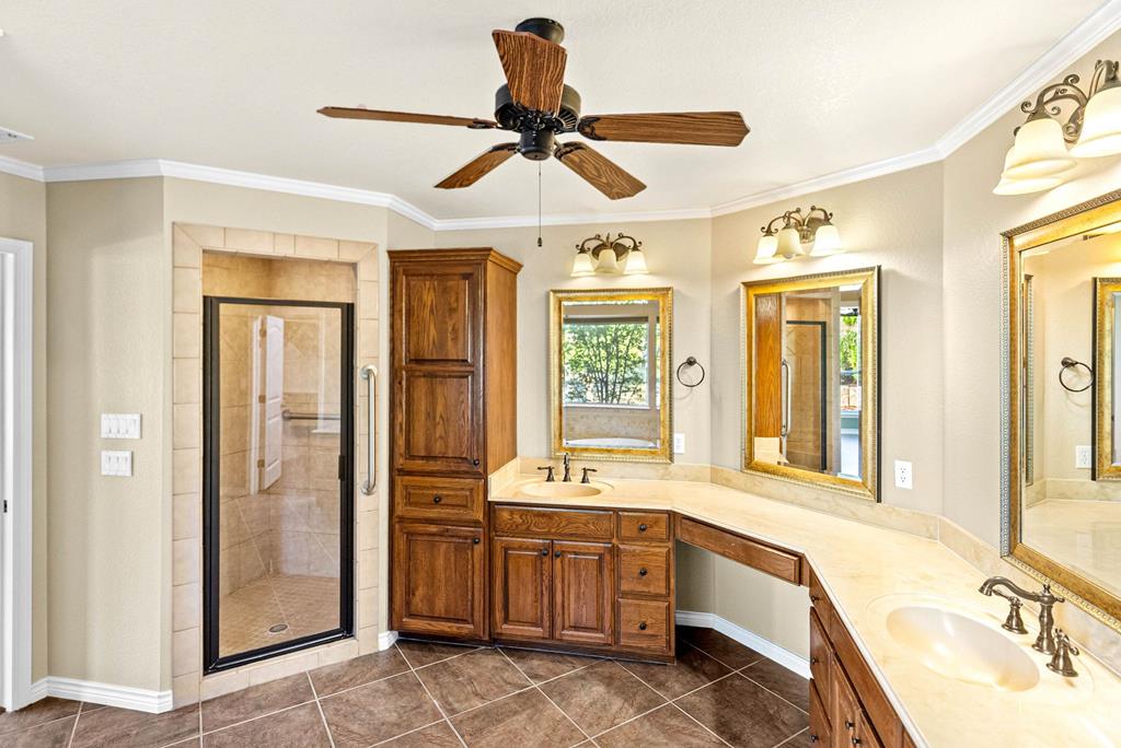 103 Cranbrook Court Ingram, TX 78025 - Photo 21 of 61 a bathroom with a tub sink shower and a mirror