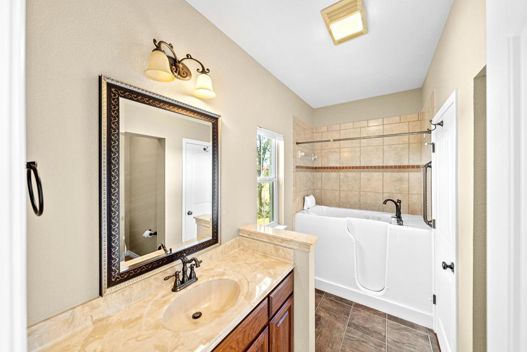 103 Cranbrook Court Ingram, TX 78025 - Photo 28 of 61 a bathroom with a sink and a mirror
