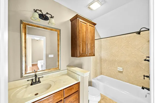 a view of a room with a ceiling fan and a window