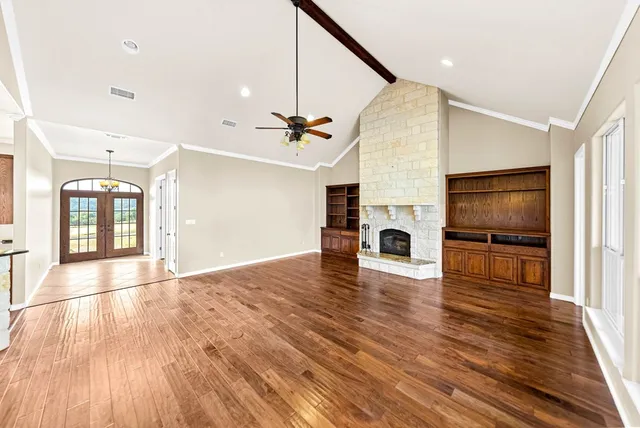 a view of empty room with wooden floor
