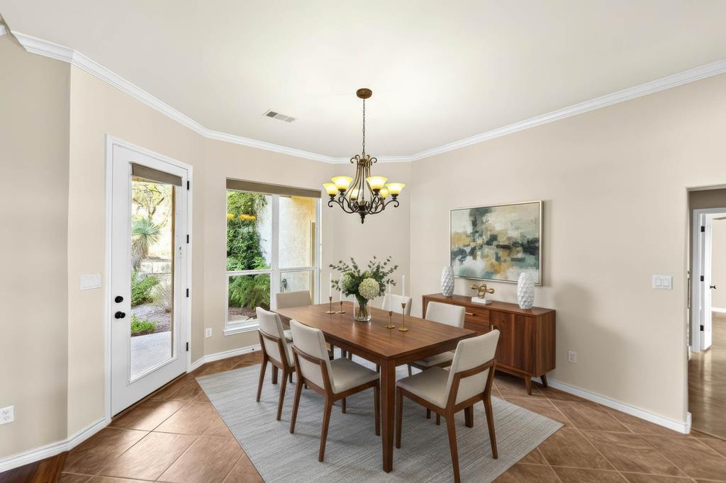 103 Cranbrook Court Ingram, TX 78025 - Photo 10 of 61 a dining room with furniture a chandelier and wooden floor