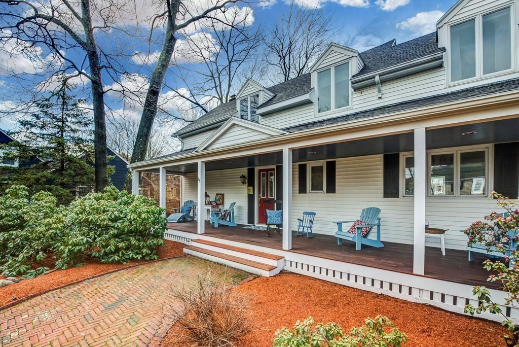 16 Spring Street Wakefield, MA 01880 - Photo 3 of 23 front view of a house with a large window and potted plants