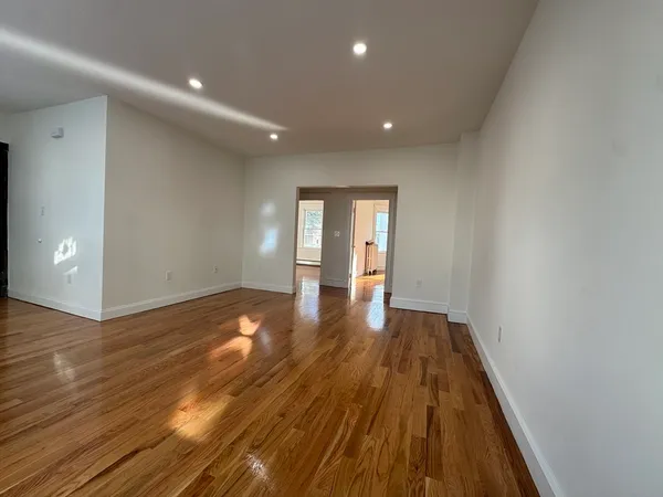 a view of a room with wooden floor