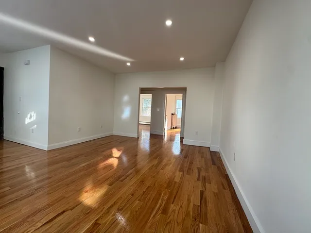 a view of a room with wooden floor