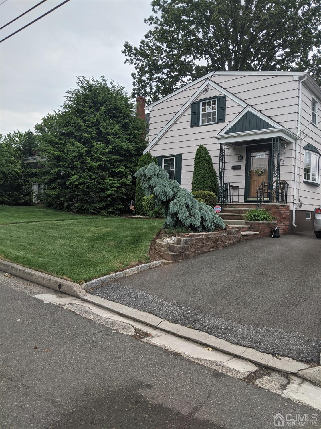 73 Highfield Road Colonia, NJ 07067 - Photo 1 of 16 a front view of a house with a yard