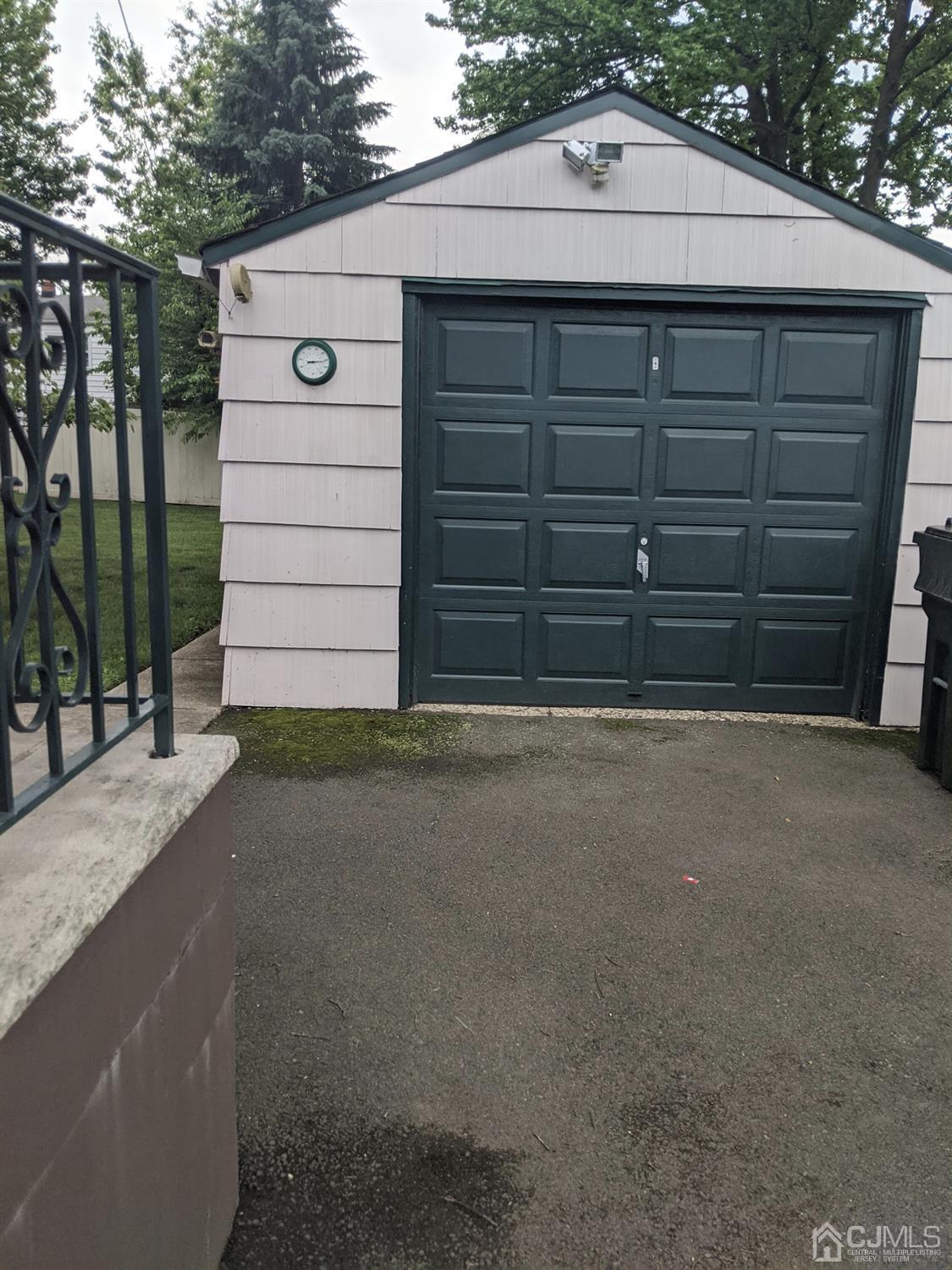 73 Highfield Road Colonia, NJ 07067 - Photo 14 of 16 a front view of a house with a garage