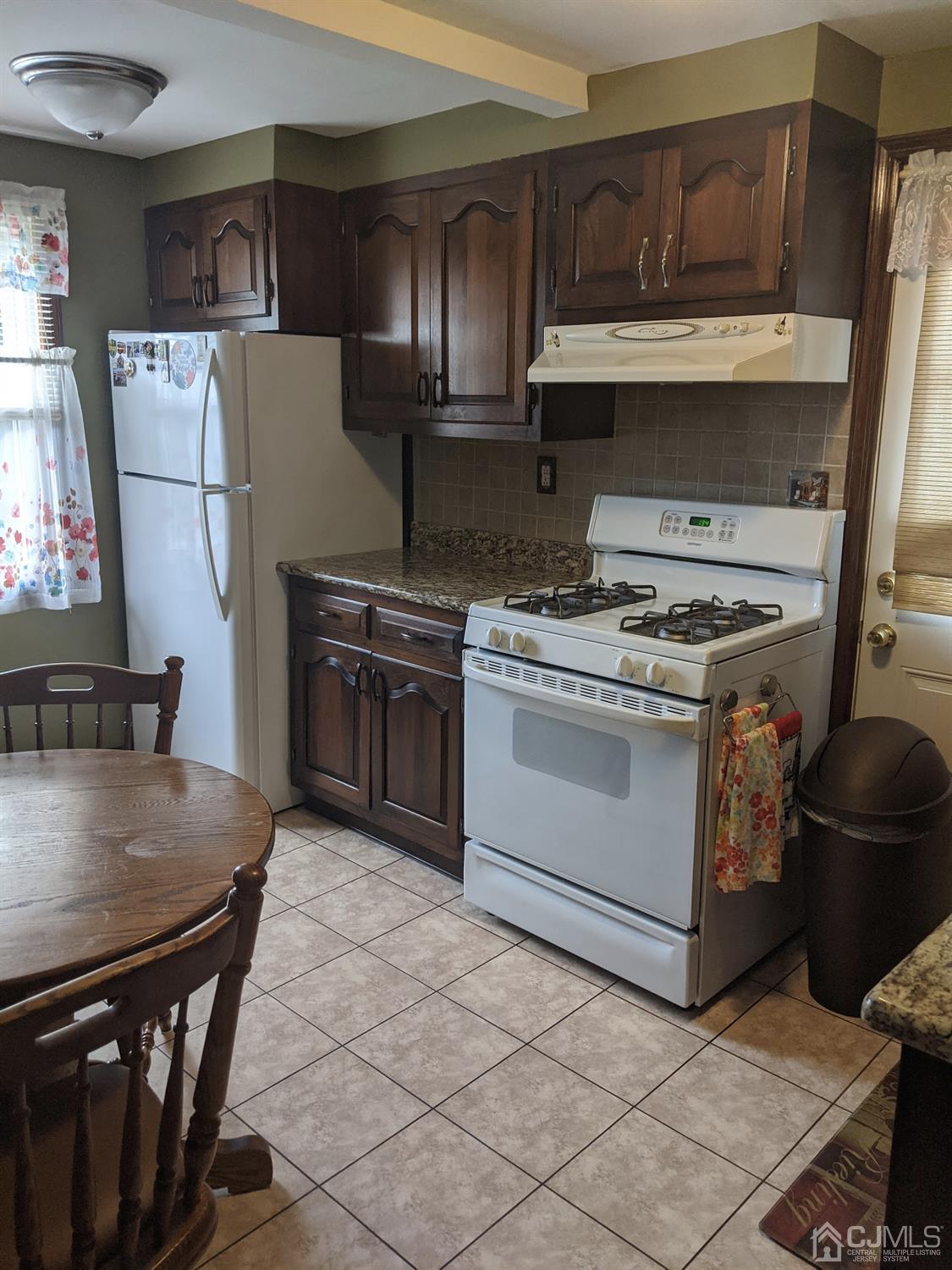 73 Highfield Road Colonia, NJ 07067 - Photo 3 of 16 a kitchen with a stove top oven and refrigerator