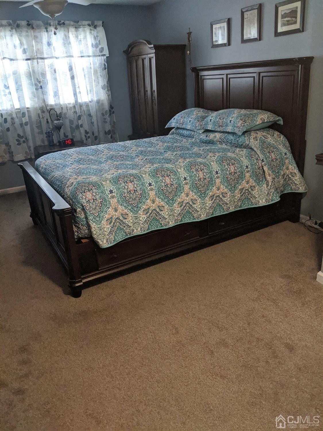 73 Highfield Road Colonia, NJ 07067 - Photo 10 of 16 a bed sitting in a bedroom next to a window