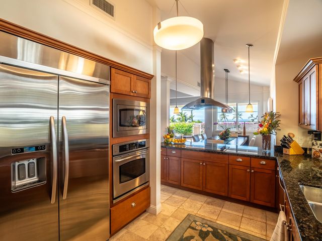 a living room with furniture and a large window with garden view