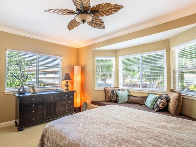 a bedroom with a bed and a couch next to a window