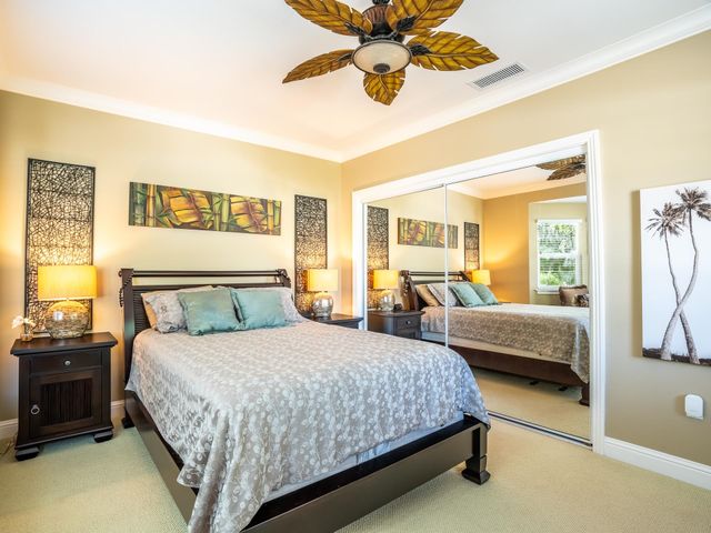 a bathroom with a granite countertop sink a mirror a bathtub and shower