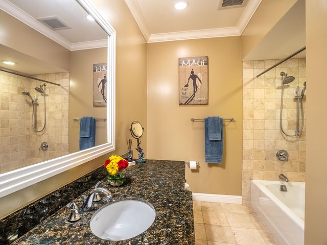 a view of a white house with a large pool and a yard in front of it