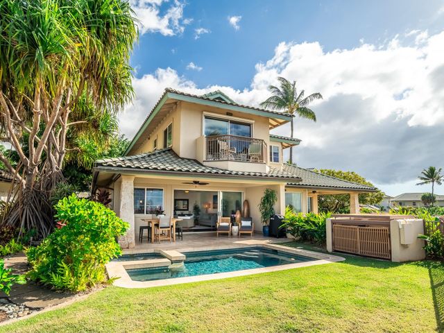 a view of a house with sitting area and garden